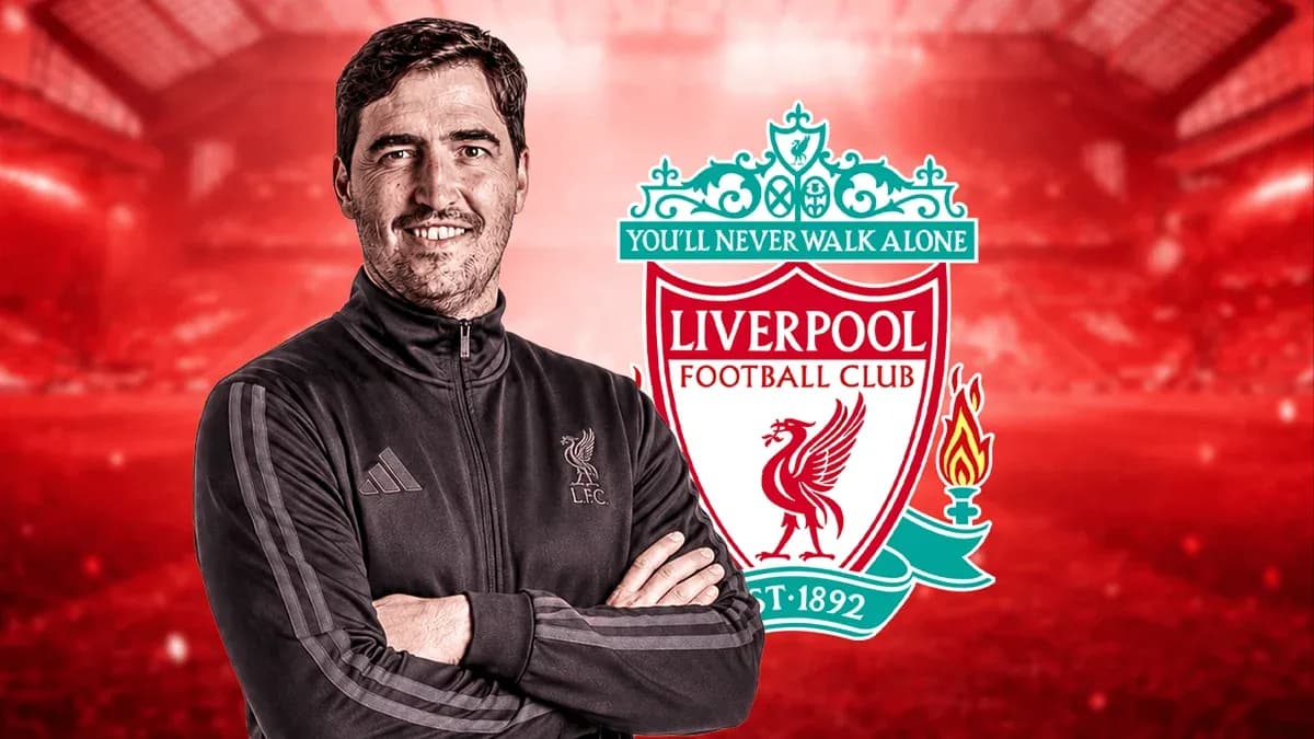Man in Liverpool FC jacket with club logo backdrop