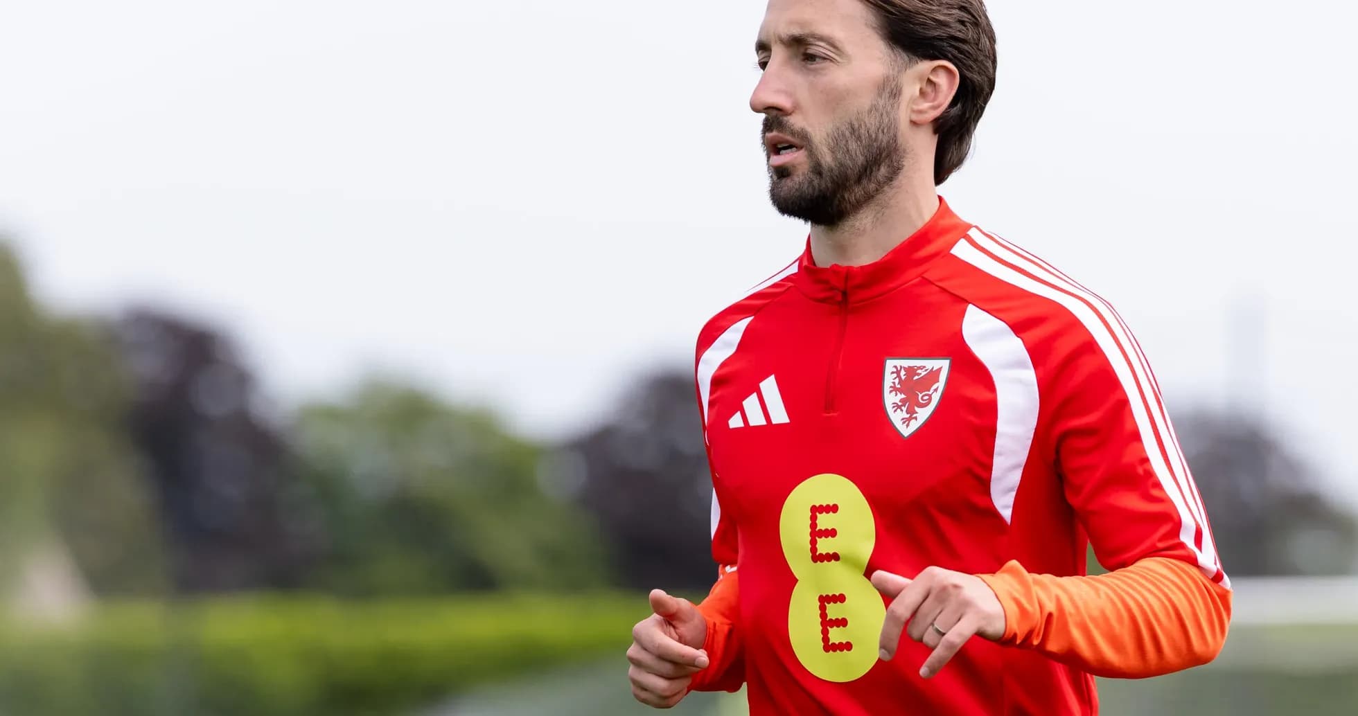 Player jogging during training session in red kit