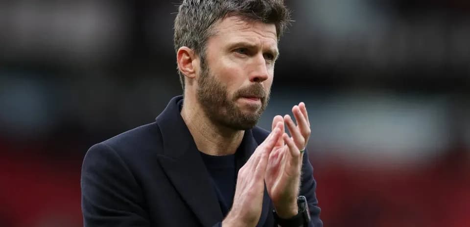 Coach applauding on the pitch during match
