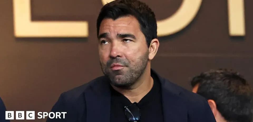 Man in a blazer at a sports event