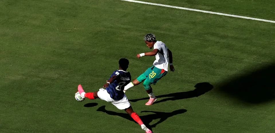 Player evading a tackle during a soccer match