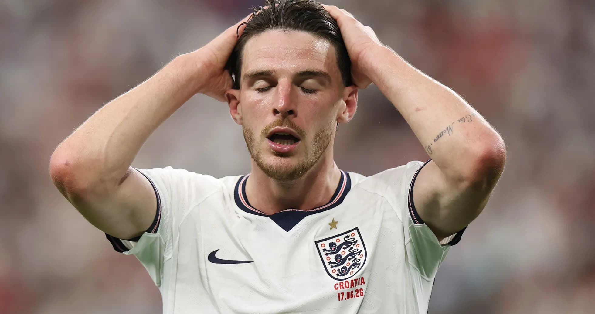 Player in England jersey with hands on head