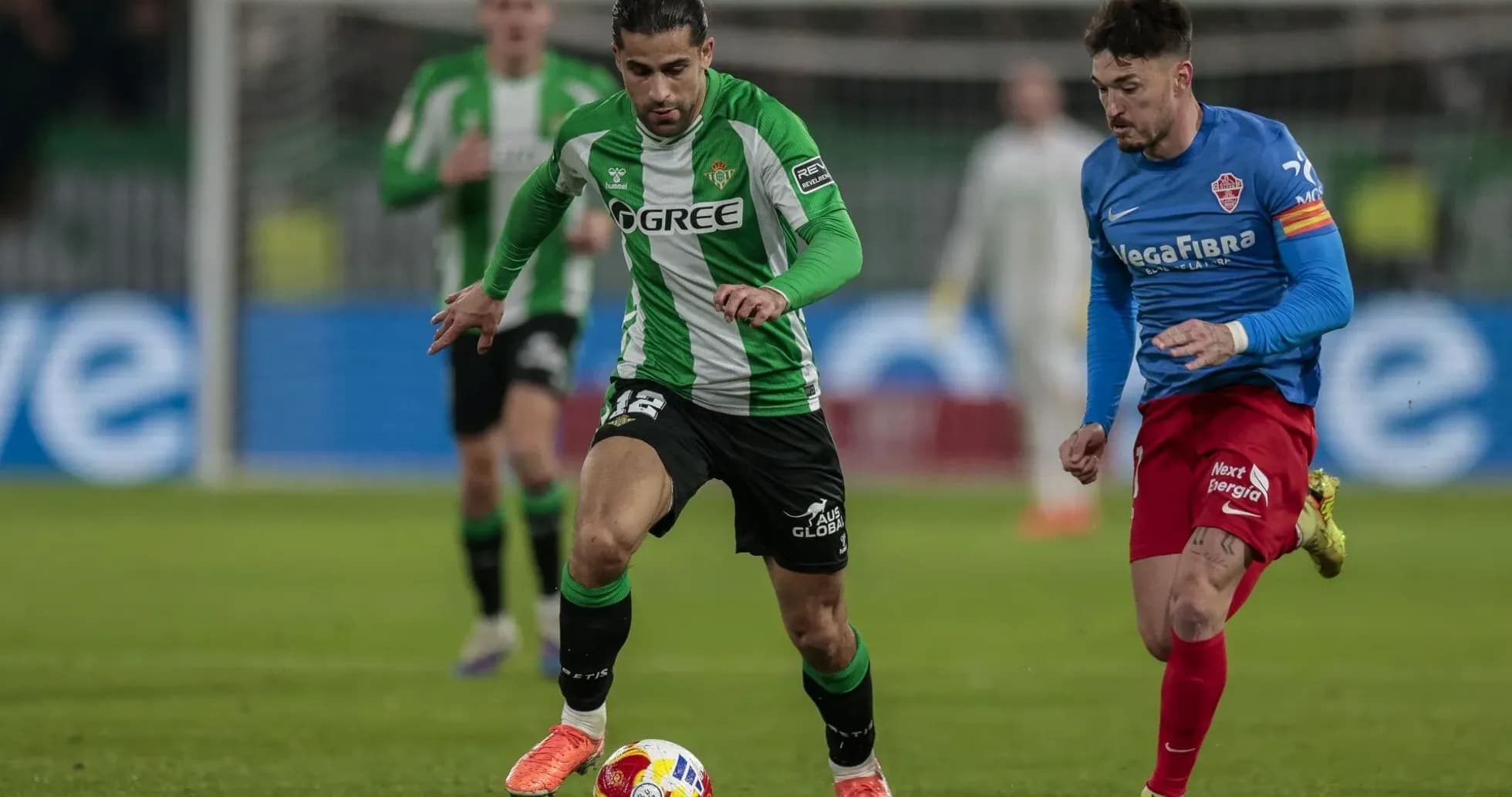 Real Betis player dribbling against Elche opponent