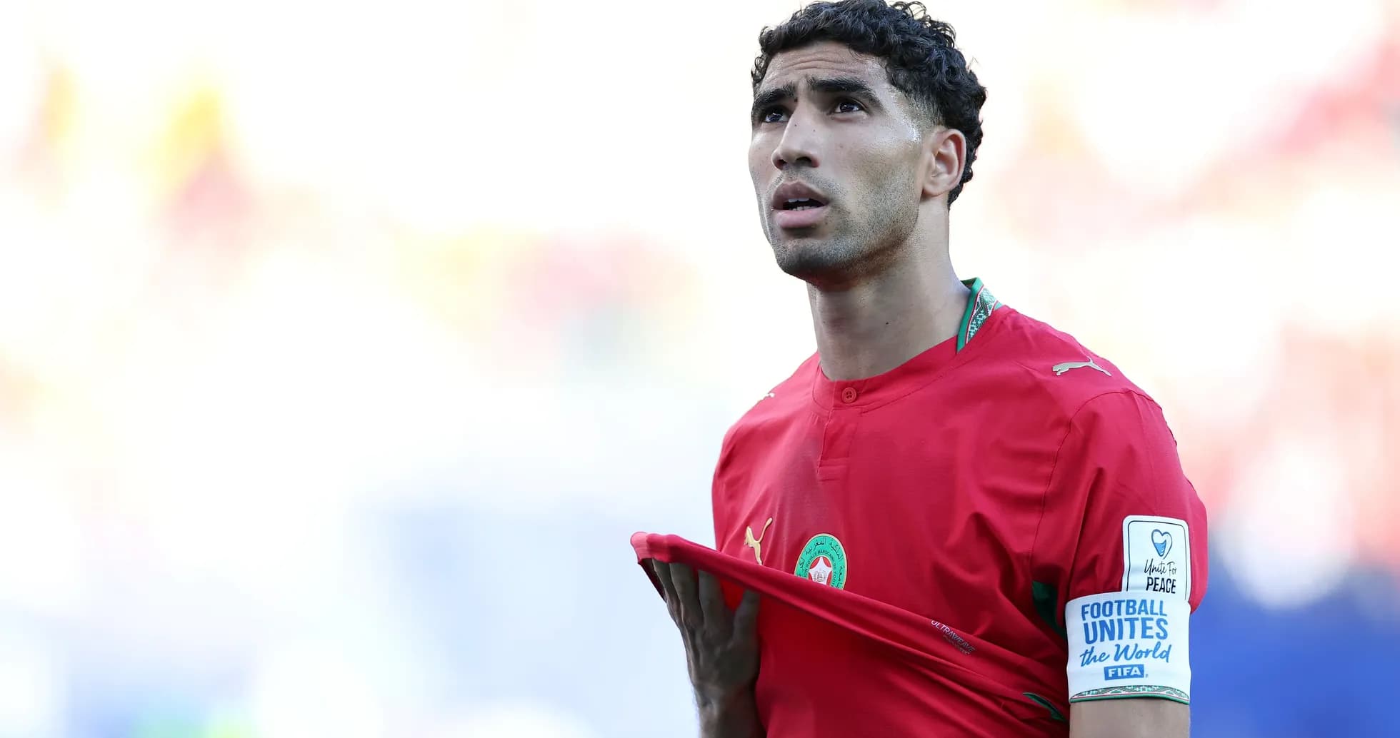 Morocco player adjusting jersey during match
