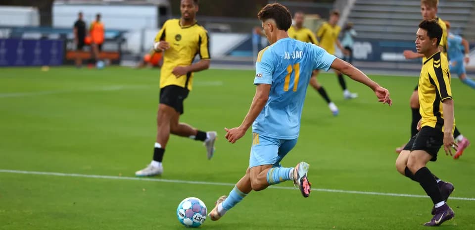 Player in light blue jersey kicking football