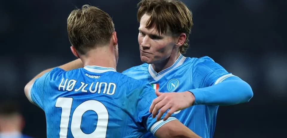 Two Napoli players embracing during a match