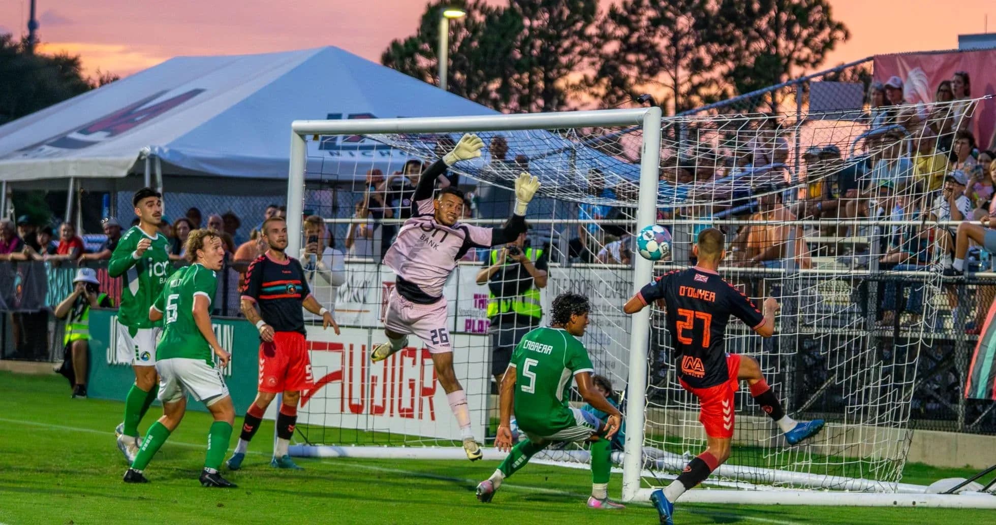 Goalkeeper attempting to save a shot on goal
