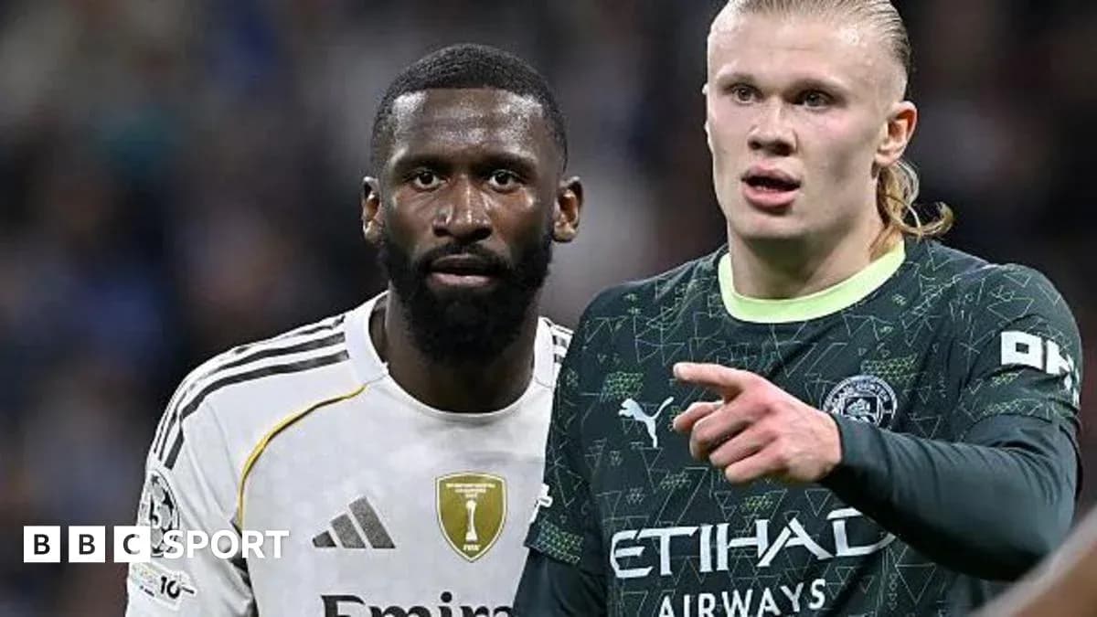 Two football players in intense discussion on pitch
