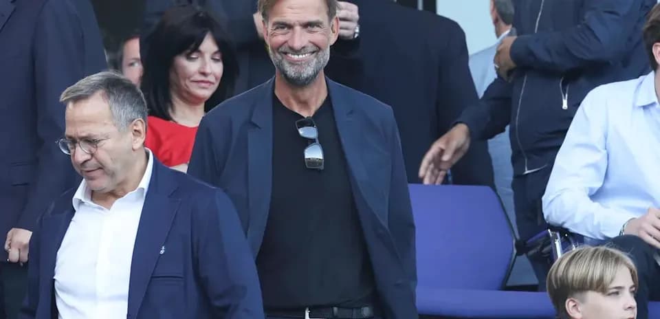 Two men walking in a stadium seating area