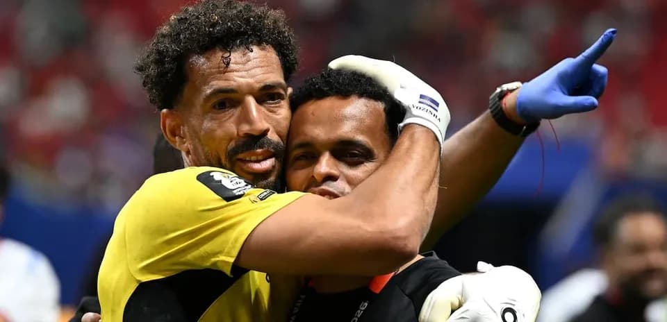 Goalkeeper and coach celebrating after match victory