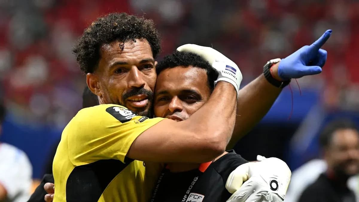 Goalkeeper and coach celebrating after match victory