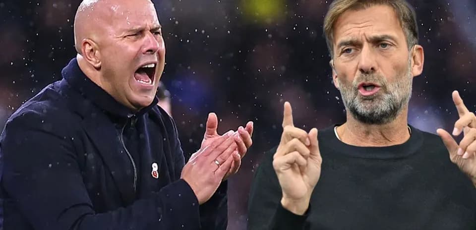 Two football managers discussing strategies during match