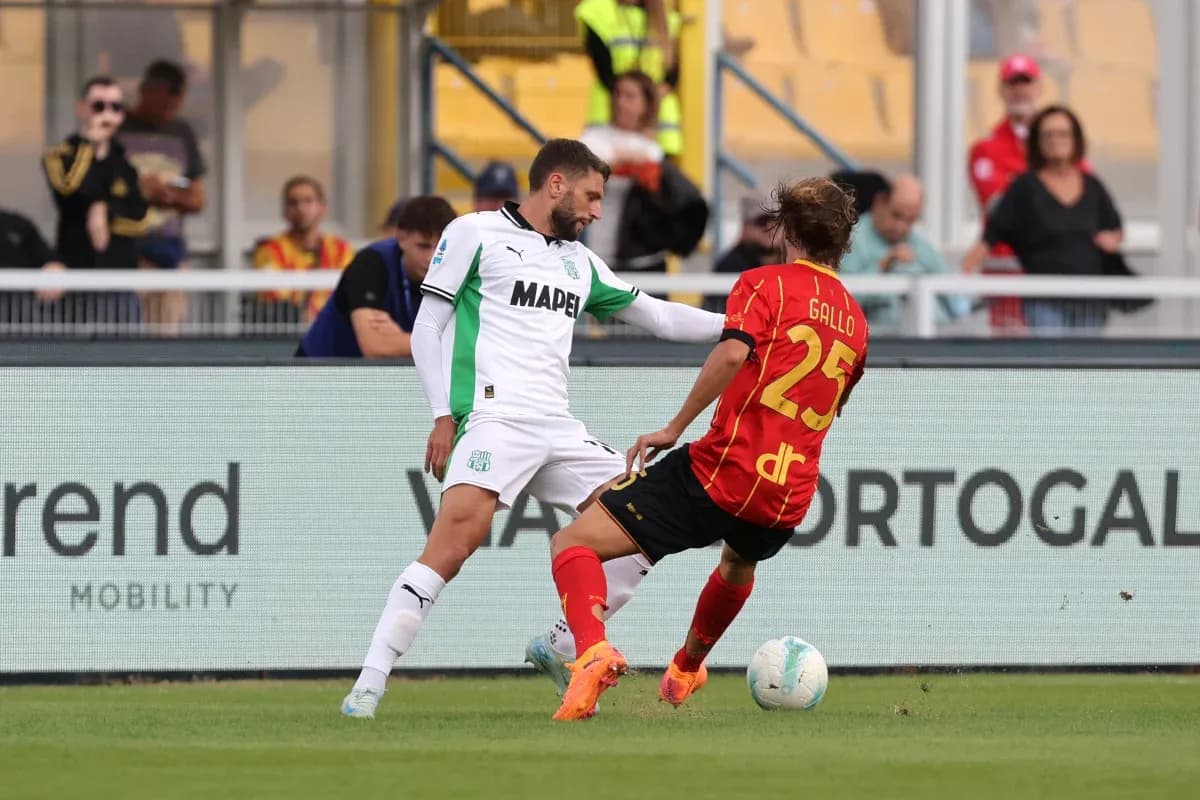 Sassuolo player challenges Lecce opponent for the ball