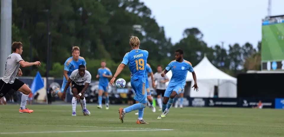 Player passing ball during Sporting JAX match
