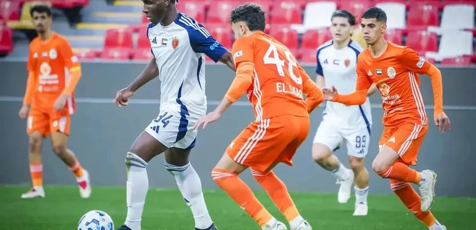 Khorfakkan U23 player dribbling past Al Sharjah U23 opponents