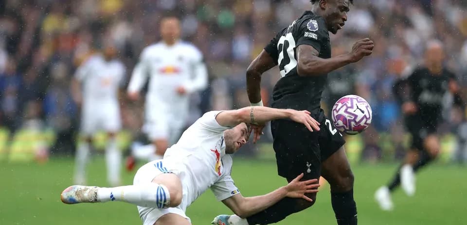 Player running with the ball while opponent falls