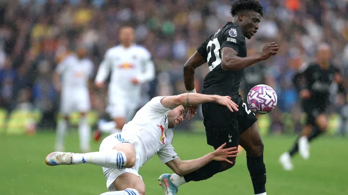 Player running with the ball while opponent falls