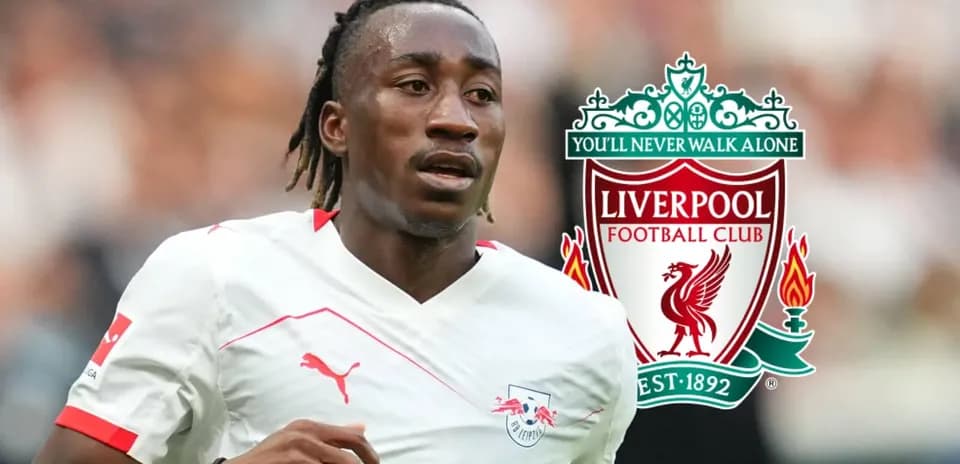 Player running with ball, Liverpool logo in background
