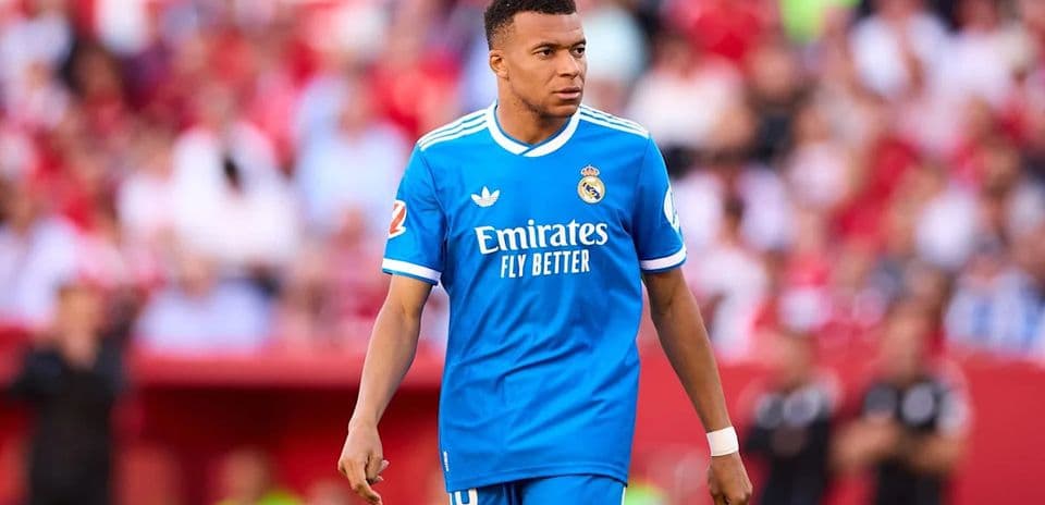 Player wearing blue Real Madrid kit on the field