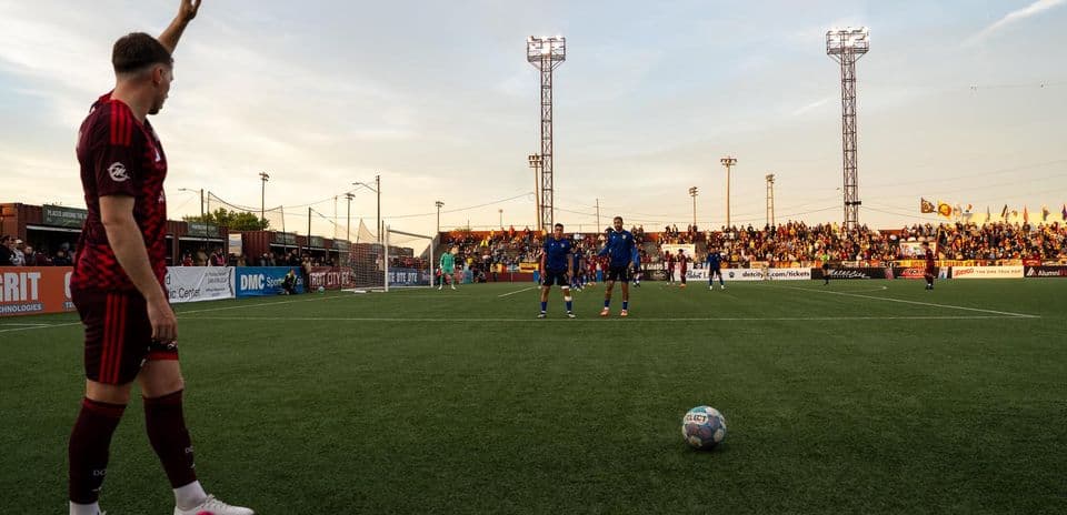 Players preparing for free kick during match