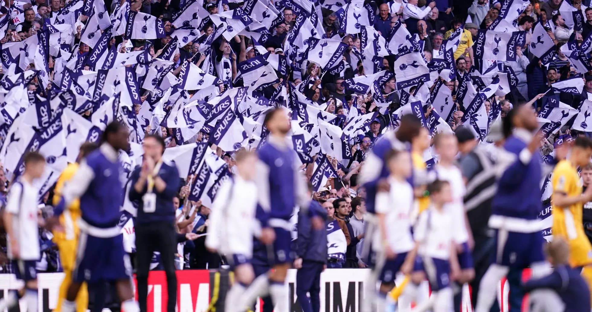 Fans waving flags during a Tottenham match