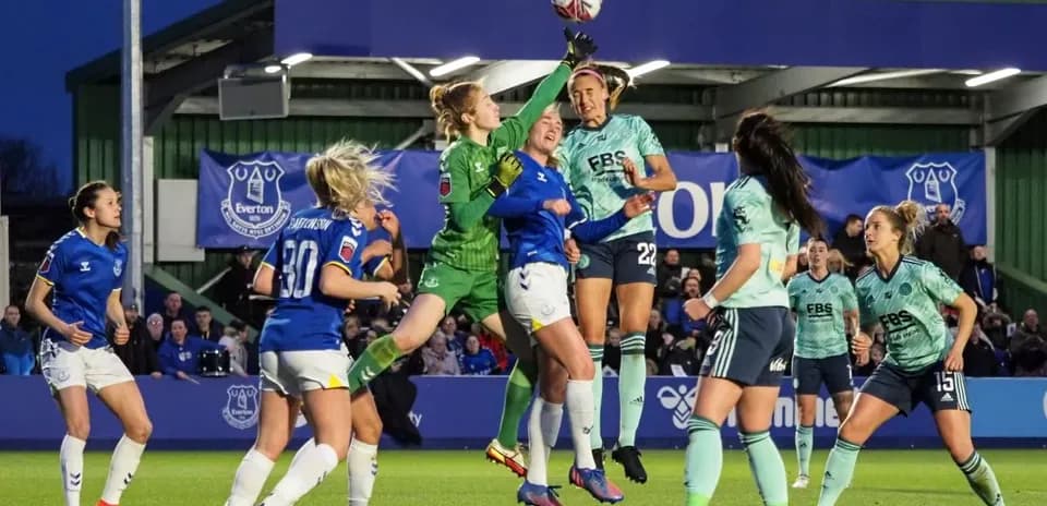 Goalkeeper reaching for the ball during match