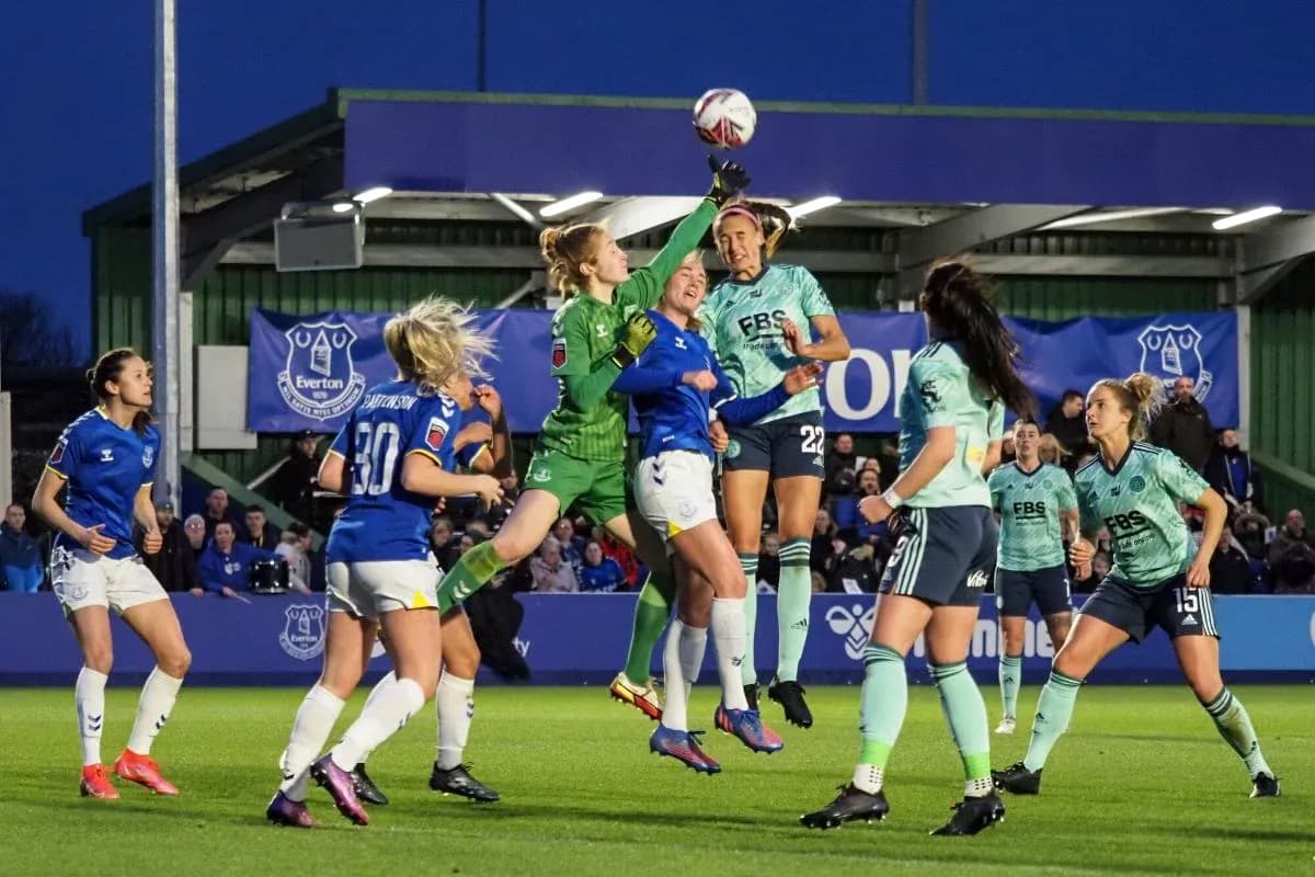 Goalkeeper reaching for the ball during match