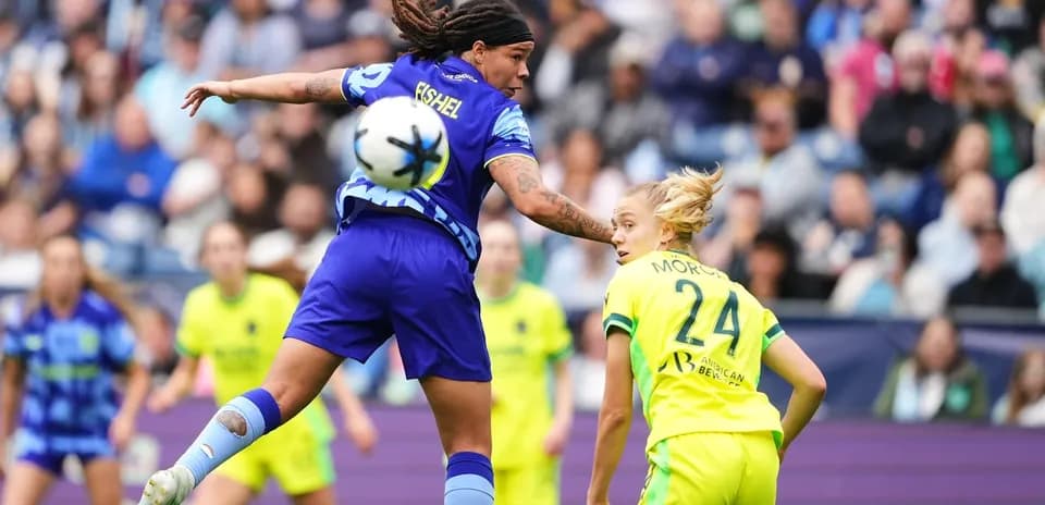 Two players competing for the ball in NWSL match