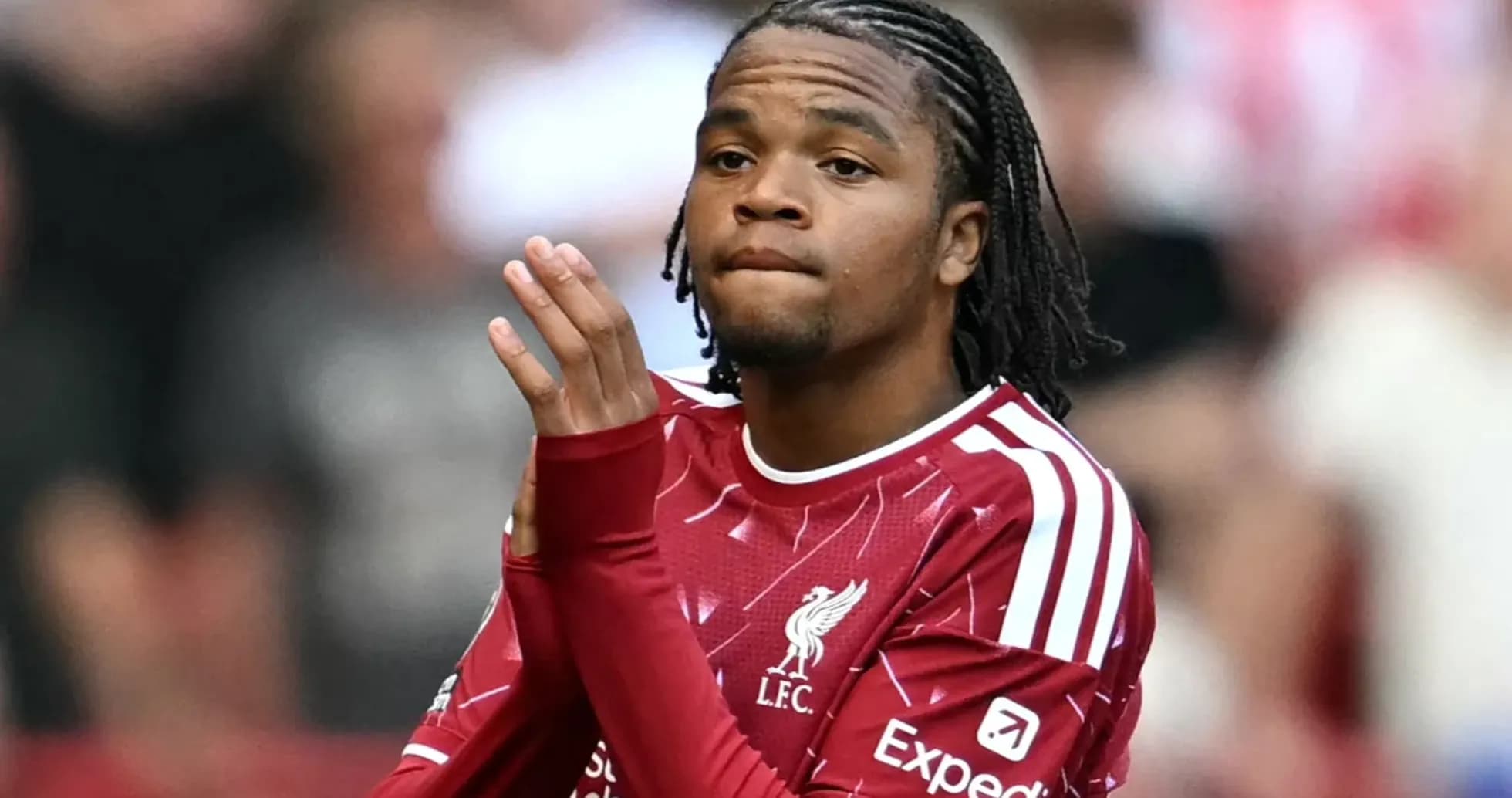 Player in Liverpool kit gesturing during match