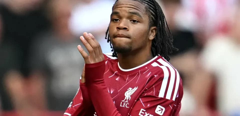 Player in Liverpool kit gesturing during match