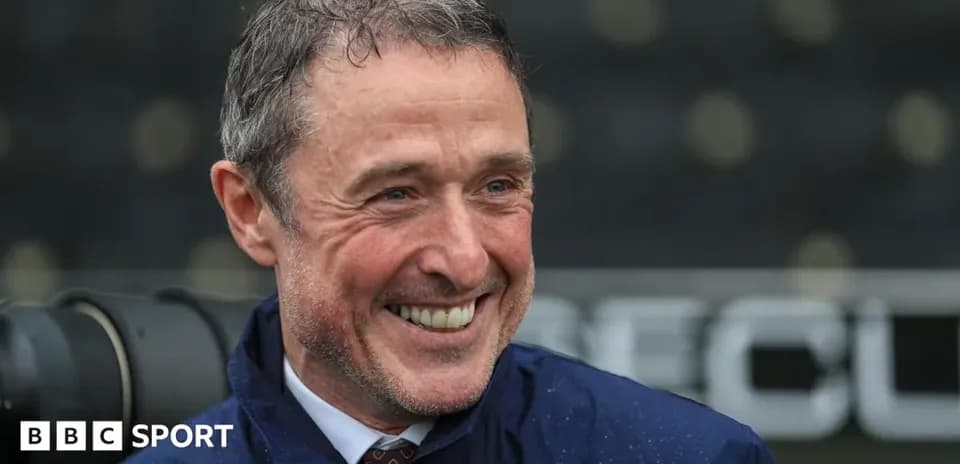 Man smiling during a rainy sports event
