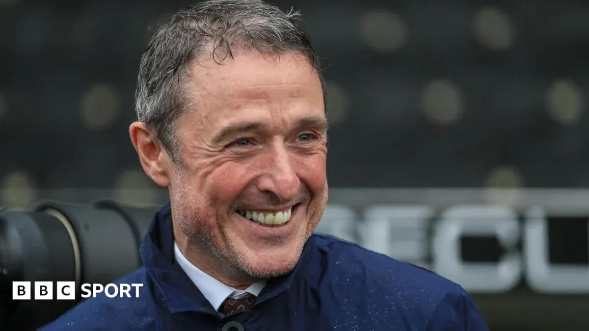 Man smiling during a rainy sports event
