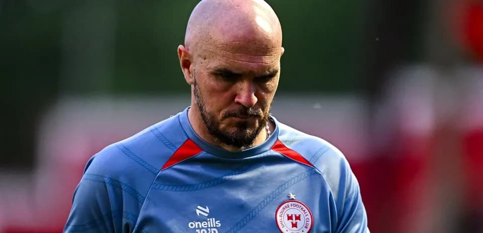 Player in training gear walking with focused expression