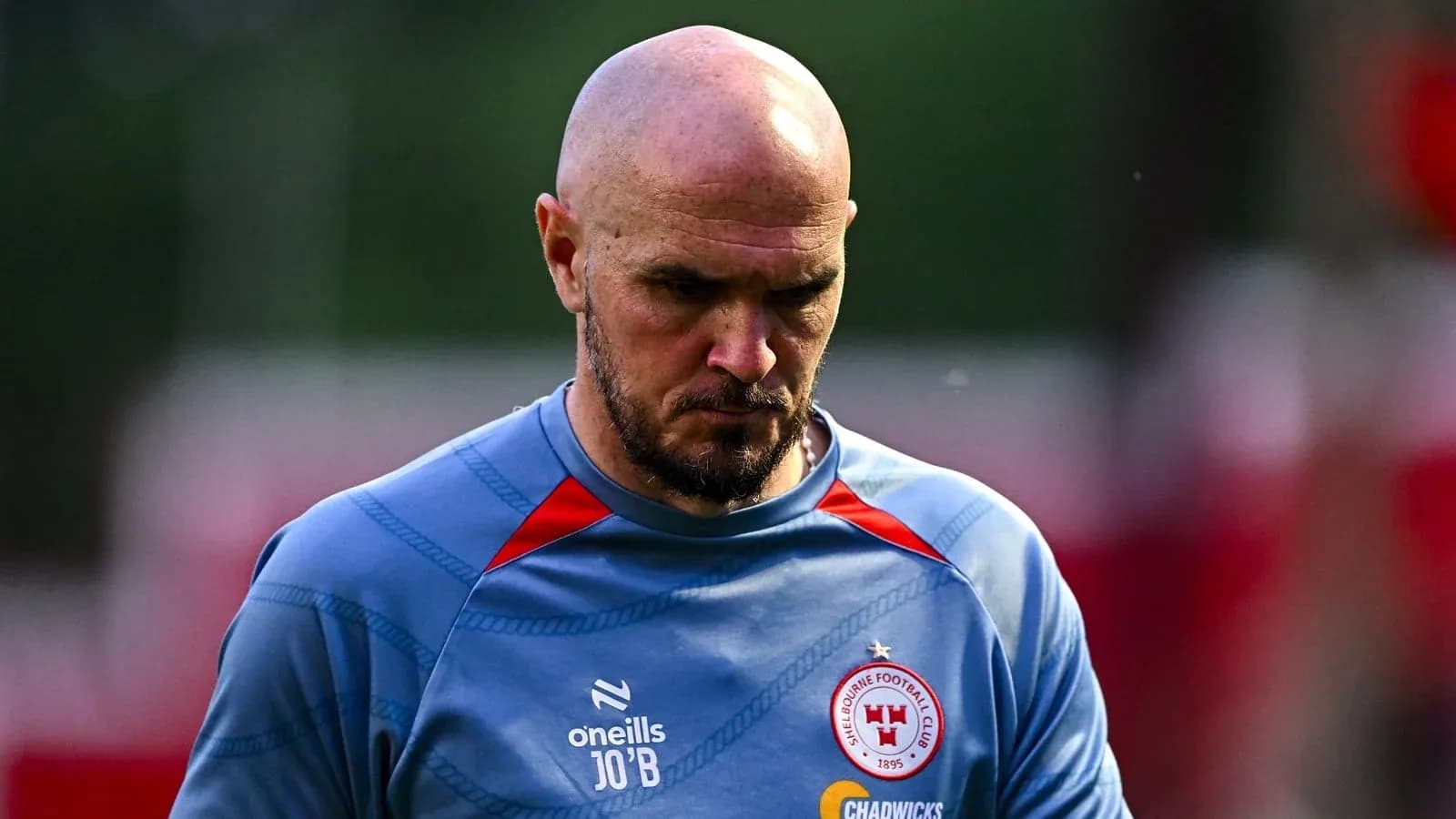 Player in training gear walking with focused expression