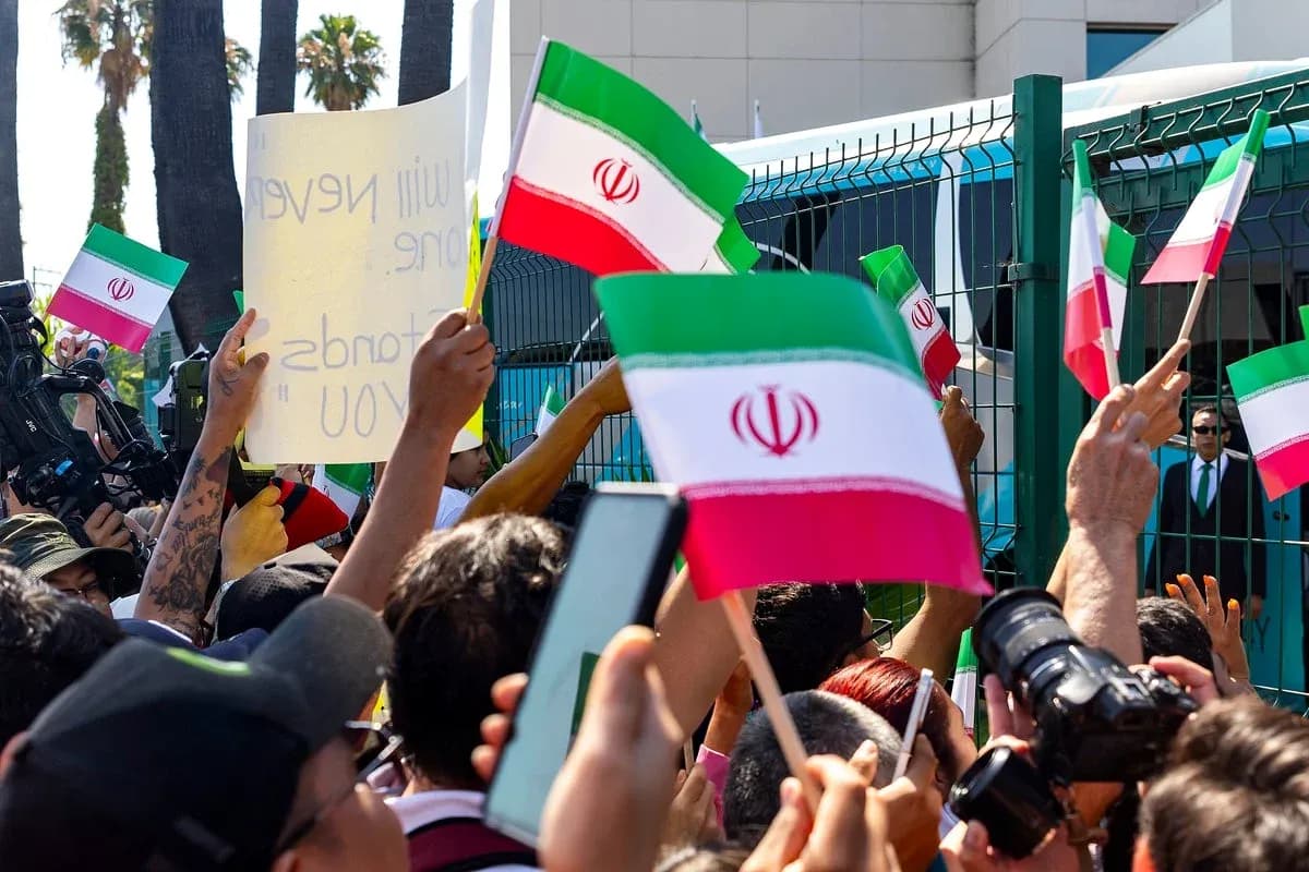 Crowd holding Iranian flags during a protest