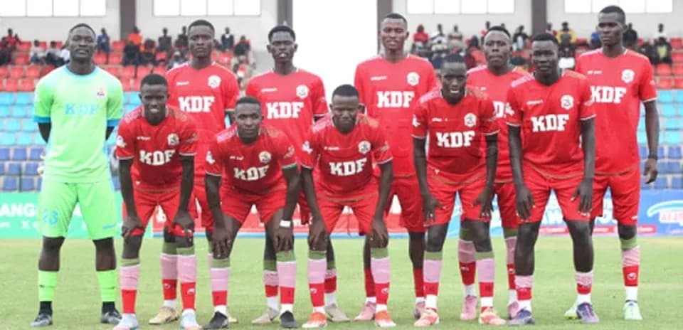 KDF football team posing for group photo on field