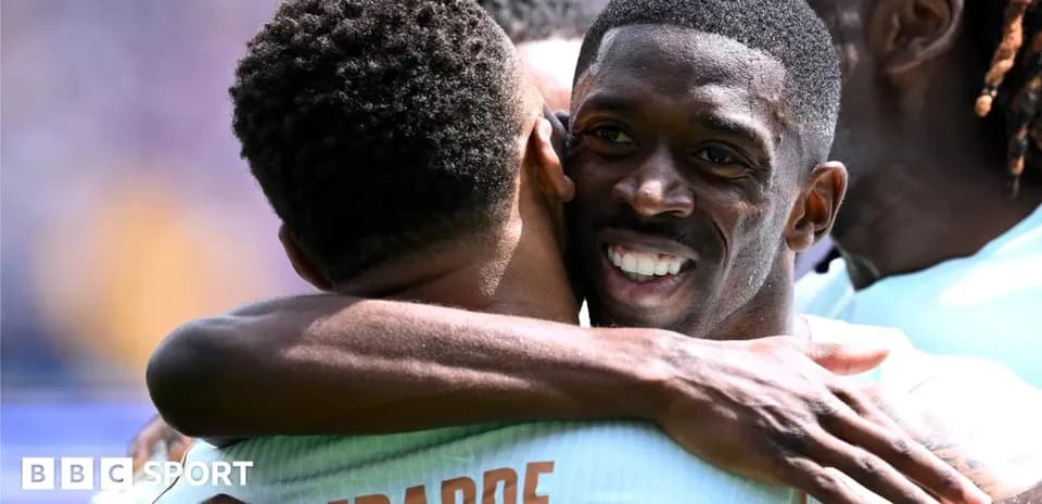 Players celebrating with a hug on the field
