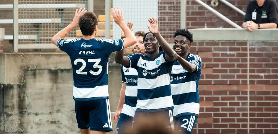 Players celebrating a goal during match