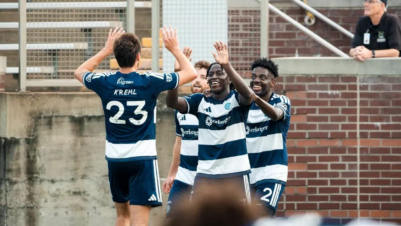 Players celebrating a goal during match