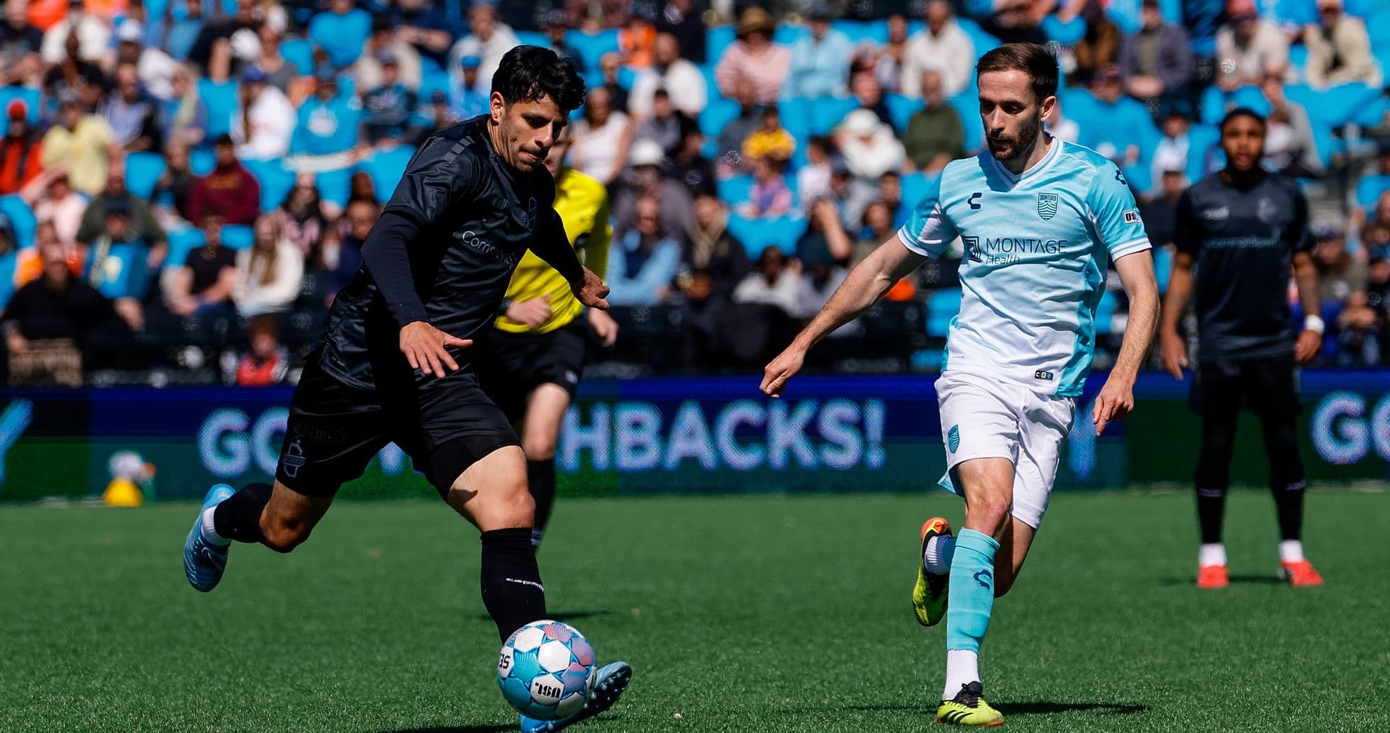 Monterey Bay player dribbling against Loudoun United
