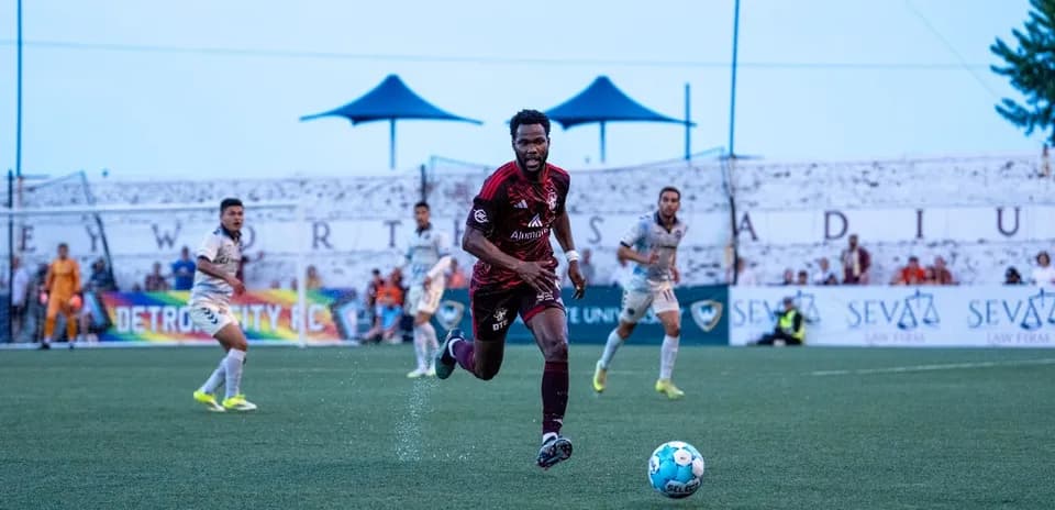 Player running with ball during Detroit City match
