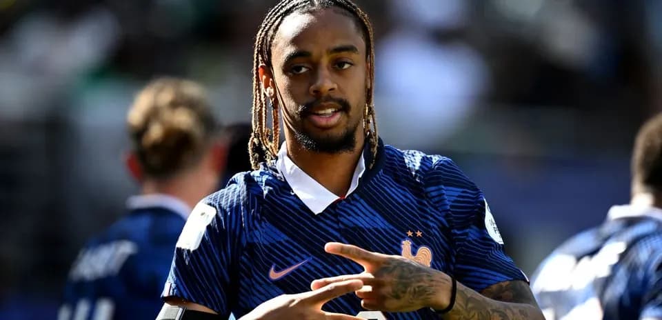 Player gesturing during warm-up in team jersey