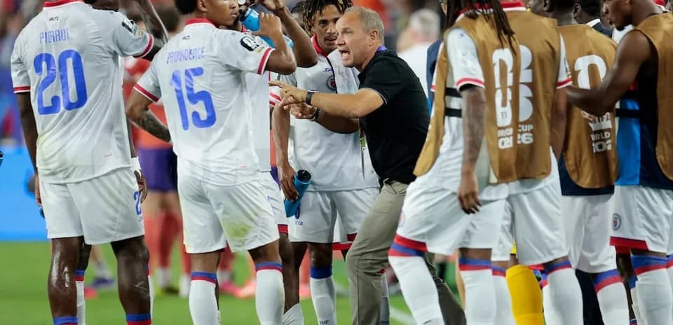 Haiti players receiving instructions during match