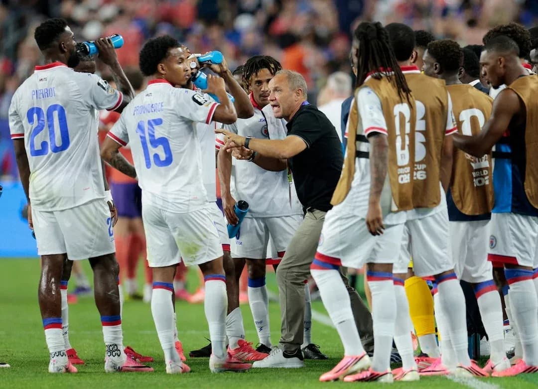 Haiti players receiving instructions during match