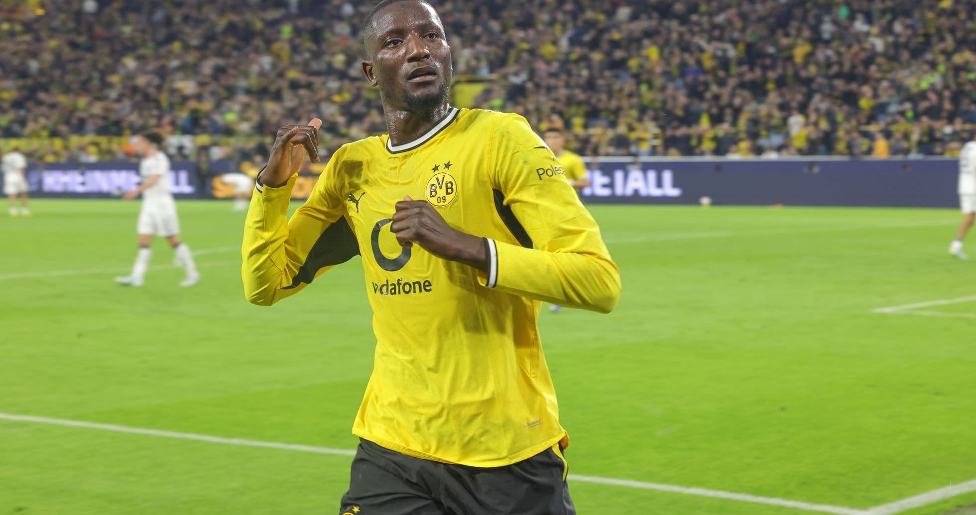 Player celebrating in Borussia Dortmund jersey on pitch