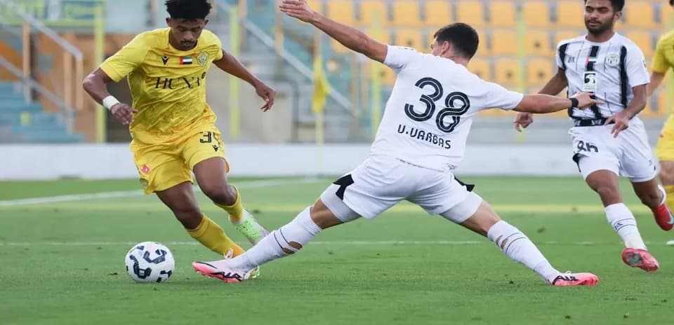 Player dribbling past defender during U23 match