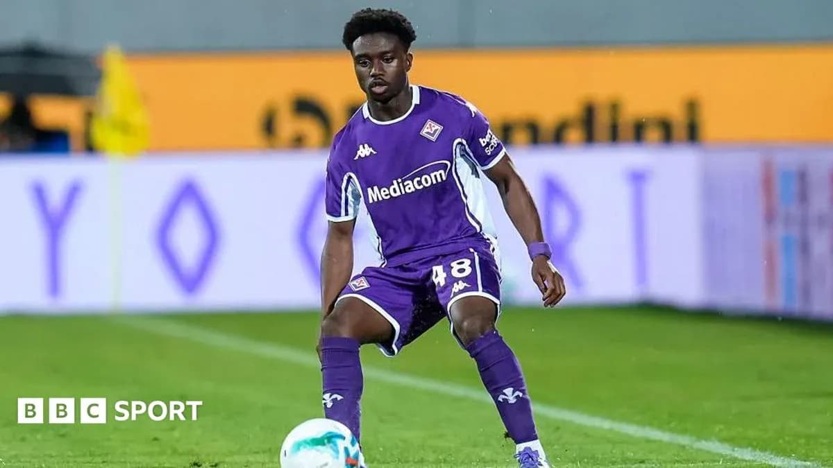Player in purple kit preparing to pass ball