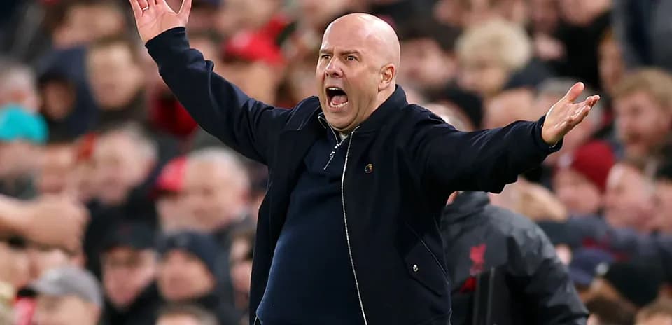 Coach gesturing animatedly on the sidelines during match