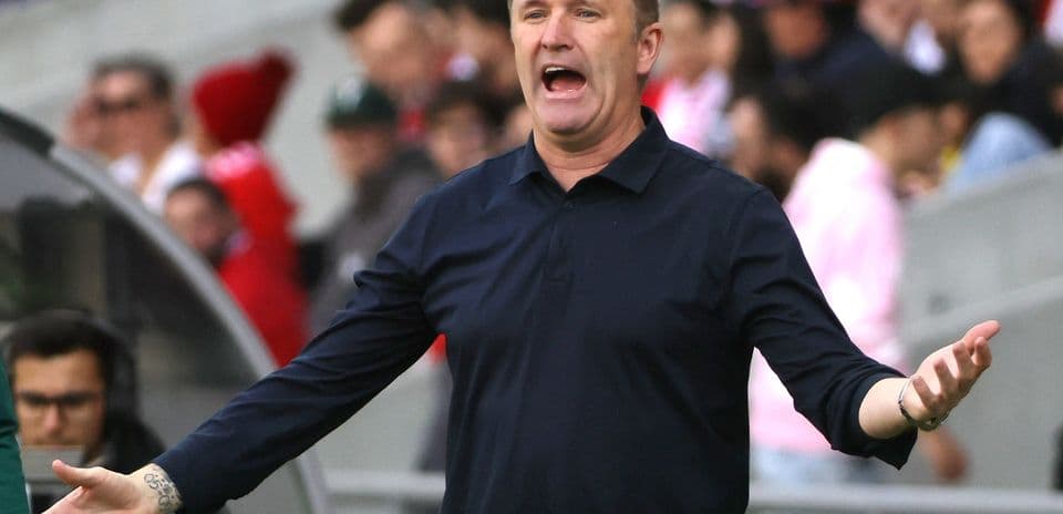 Coach gesturing passionately on the sidelines