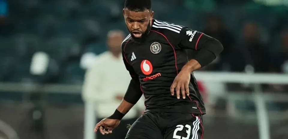 Player in black jersey dribbling ball on field